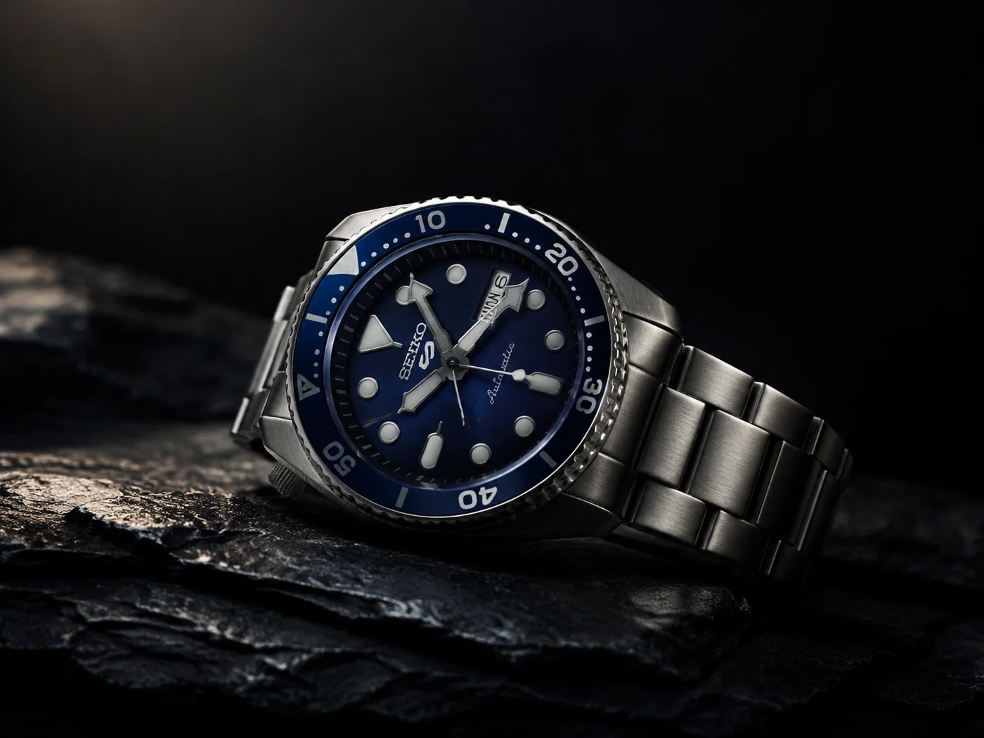 Seiko 5 Sports automatic watch blackout mod with ceramic bezel on dark surface
